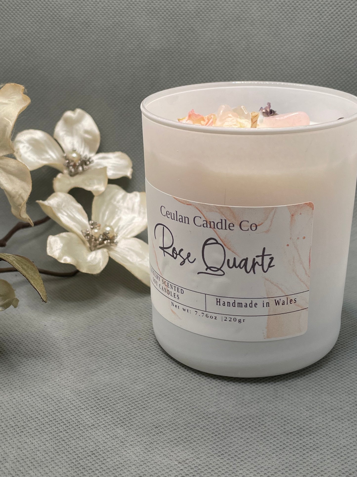 Rose Quartz soy wax candle with crystals & botanicals .